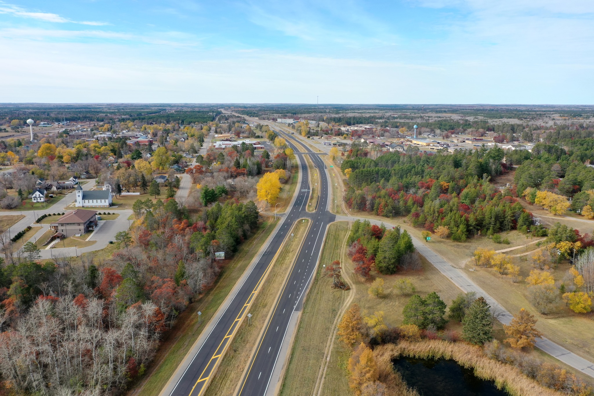 Highway 371 after construction, showing a new sidewalk, lane adjustment, and shared-use path.