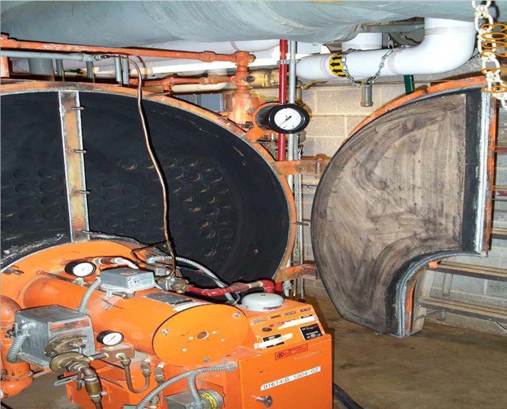 Boiler room with gray, crescent-shaped refractory mold visible against back wall.