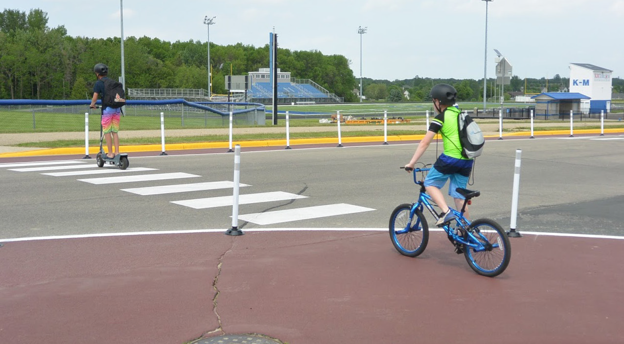 image of two students crossing the road by an installed demonstration project